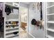 Organized closet with shelves, rods, and hooks for efficient storage and showcasing a bathroom at 325 Meadows Ln, Canton, GA 30114
