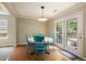 Sunny dining room featuring hardwood floors, light-colored walls, and a door to the backyard at 325 Meadows Ln, Canton, GA 30114