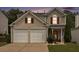 Charming two-story home with a two-car garage and manicured front lawn at 325 Meadows Ln, Canton, GA 30114