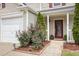 Home's entrance with landscaped garden bed and a red front door at 325 Meadows Ln, Canton, GA 30114