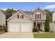 Two-story home with a two car garage, neutral siding, and landscaped front yard at 325 Meadows Ln, Canton, GA 30114