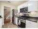 Modern kitchen features stainless steel appliances and dark countertops at 325 Meadows Ln, Canton, GA 30114
