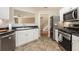 Kitchen with stainless steel appliances and white cabinetry at 325 Meadows Ln, Canton, GA 30114