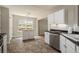 Charming eat-in kitchen featuring stainless steel appliances and views to the backyard at 325 Meadows Ln, Canton, GA 30114