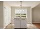 Eat-in kitchen features a moveable island, light-colored walls, and tile floor at 325 Meadows Ln, Canton, GA 30114