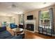 Cozy living room with a fireplace, hardwood floors, and stylish decor at 325 Meadows Ln, Canton, GA 30114
