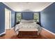 Spacious main bedroom featuring wood floors, a ceiling fan, and plenty of natural light at 325 Meadows Ln, Canton, GA 30114