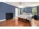 Spacious main bedroom with hardwood floors, a ceiling fan, and two windows at 325 Meadows Ln, Canton, GA 30114