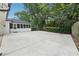 Concrete patio and screened porch overlooking a lush backyard at 5631 Queensborough Dr, Atlanta, GA 30338