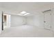 Spacious finished basement featuring neutral carpet, white walls, and bright skylight at 5631 Queensborough Dr, Atlanta, GA 30338