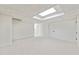 Finished basement with neutral carpet, bright lighting, and storage at 5631 Queensborough Dr, Atlanta, GA 30338