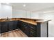 Finished basement features a stylish bar with attractive black cabinetry and countertop at 5631 Queensborough Dr, Atlanta, GA 30338