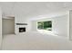 Large finished basement featuring painted brick fireplace and sliding glass door at 5631 Queensborough Dr, Atlanta, GA 30338