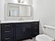 Modern bathroom vanity with marble countertop, navy blue cabinets, and gold hardware accents at 5631 Queensborough Dr, Atlanta, GA 30338