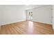 A spare bedroom with hardwood flooring, a large window, and neutral paint to allow personalization at 5631 Queensborough Dr, Atlanta, GA 30338