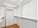 A well-organized closet with shelving and metal rods for hanging clothes and accessories at 5631 Queensborough Dr, Atlanta, GA 30338