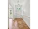 Elegant entryway featuring herringbone hardwood floors, wainscoting and a decorative light fixture at 5631 Queensborough Dr, Atlanta, GA 30338