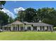Charming single story home with white brick, black shutters and beautifully manicured lawn at 5631 Queensborough Dr, Atlanta, GA 30338