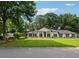 Inviting exterior view of home featuring a lush green lawn and mature trees at 5631 Queensborough Dr, Atlanta, GA 30338