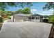 Home exterior with oversized back driveway, garage, and screened porch at 5631 Queensborough Dr, Atlanta, GA 30338