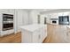 Bright kitchen island offers a view of a living space with a fireplace at 5631 Queensborough Dr, Atlanta, GA 30338