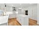 Modern kitchen boasts an island, stainless steel appliances, and hardwood floors at 5631 Queensborough Dr, Atlanta, GA 30338