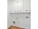 Simple laundry room featuring overhead cabinets and utility hookups at 5631 Queensborough Dr, Atlanta, GA 30338