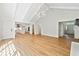 Open-concept living room with hardwood floors, connecting to the kitchen at 5631 Queensborough Dr, Atlanta, GA 30338