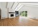 Spacious living room with fireplace, vaulted ceiling, and hardwood floors at 5631 Queensborough Dr, Atlanta, GA 30338