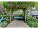 Backyard garden swing with wooden walkway and mature landscaping at 785 Cirrus Dr, Johns Creek, GA 30022