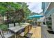 Relaxing backyard deck with an umbrella-covered dining set and comfortable seating at 785 Cirrus Dr, Johns Creek, GA 30022