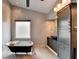Stylish bathroom with a classic soaking tub and modern grey vanity and storage at 785 Cirrus Dr, Johns Creek, GA 30022