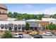 A bustling commercial district showing buildings, a row of stores and breweries with outdoor seating, and street-side parking at 785 Cirrus Dr, Johns Creek, GA 30022