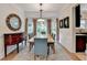 Bright dining room featuring a large table, tufted chairs, bay window, and elegant decor at 785 Cirrus Dr, Johns Creek, GA 30022