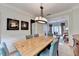 Formal dining area with a large wooden table, seating for six, and stylish lighting fixture at 785 Cirrus Dr, Johns Creek, GA 30022