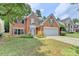 Charming two-story brick home with an attached two-car garage and manicured front lawn at 785 Cirrus Dr, Johns Creek, GA 30022