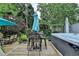 Backyard deck area with hot tub, seating, and lush landscaping at 785 Cirrus Dr, Johns Creek, GA 30022