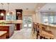 Open kitchen layout with stainless steel appliances, bar stool seating and granite countertops at 785 Cirrus Dr, Johns Creek, GA 30022