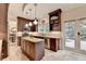 Well-appointed kitchen with island, stone tile backsplash, stainless appliances, and granite countertops at 785 Cirrus Dr, Johns Creek, GA 30022