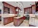 Modern kitchen featuring granite countertops, stainless steel appliances, and rich wood cabinetry at 785 Cirrus Dr, Johns Creek, GA 30022