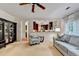 Cozy living room showcasing seamless flow to the kitchen, fireplace, large windows, and plush seating at 785 Cirrus Dr, Johns Creek, GA 30022