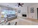 Bright living room with large windows, neutral tones, fireplace, ceiling fan, and comfortable seating at 785 Cirrus Dr, Johns Creek, GA 30022