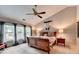 Comfortable main bedroom featuring a ceiling fan, natural light, and en-suite bathroom at 785 Cirrus Dr, Johns Creek, GA 30022