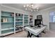 Bright home office featuring built-in bookshelves and a spacious work area at 785 Cirrus Dr, Johns Creek, GA 30022