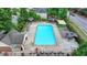 Aerial view of community pool with lounge chairs and mature trees at 785 Cirrus Dr, Johns Creek, GA 30022