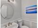 Stylishly updated powder room featuring a round mirror, modern fixtures, and tasteful decor at 785 Cirrus Dr, Johns Creek, GA 30022