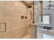Luxurious walk-in shower with elegant tile, rainfall shower head, and seamless glass enclosure in main bathroom at 785 Cirrus Dr, Johns Creek, GA 30022