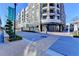 Attractive street view featuring upscale shops, apartments with balconies, and well-maintained landscaping and crosswalks at 785 Cirrus Dr, Johns Creek, GA 30022