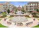 Picturesque town center showcasing a fountain, benches, and a variety of shops and apartments in a vibrant community setting at 785 Cirrus Dr, Johns Creek, GA 30022
