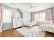 Charming bedroom featuring twin beds, a dresser, and soft pink accents, creating a cozy and inviting space at 956 Clifton Ne Rd, Atlanta, GA 30307